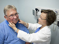 Dr. Jia Ruan examines patient Russell Meyer